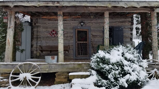 A rustic wooden cabin with a porch, stone steps, and a snow-covered landscape. - 120Yr Old Cabin Great for couple/family, 15 min from Boone, center of 200 acres! (Boone)