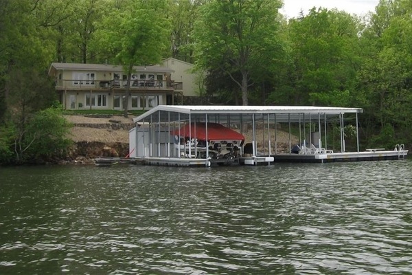 Lake Side Elevation w/ Walls of Windows Nestled in Dense Foliage