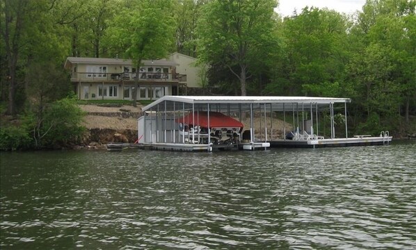 A house with a dock and a covered boat storage area. - NEWLY UPDATED!!!Amazing lakefront home (Gravois Mills)