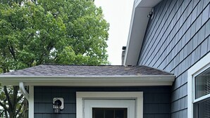 A house with a number 7834 on the door, a stone wall, and a wooden deck. - WOLCOTT NY  Waterfront cottage rental on Port Bay seasonal available 2026 (Port Bay - Wolcott)
