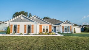 A row of modern single-family homes with a consistent architectural style, featuring gabled roofs and a mix of siding materials.