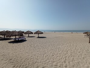 On the beach, sun loungers, beach towels