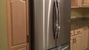 A stainless steel refrigerator with a freezer on top, built into a kitchen with light wooden cabinets and a granite countertop. - 2BD, 1 BA, BUNGALOW FOR 9 GUESTS!! ENTIRE HOUSE W/ DRIVEWAY PARKING!! (Los Angeles)