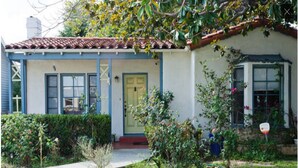 A single-story house with a front porch, a small garden, and a visible door. - 2BD, 1 BA, BUNGALOW FOR 9 GUESTS!! ENTIRE HOUSE W/ DRIVEWAY PARKING!! (Los Angeles)