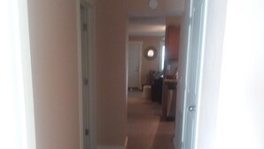 A hallway with a brick floor leading to a kitchen area. - 3 Bedroom 2 Bath Bungalow  (Mountain Grove)