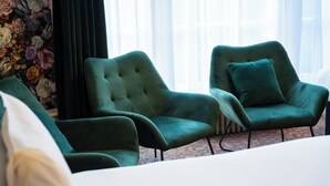 A room with three green armchairs, a white sofa, and a floral wallpaper. - City Studios - Rodney Street (Liverpool)