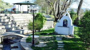 A garden with stone steps, a small white building, and a gazebo. - Lydia Hotel (Kavala)