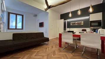 Comfort Triple Room | Living area | Flat-screen TV