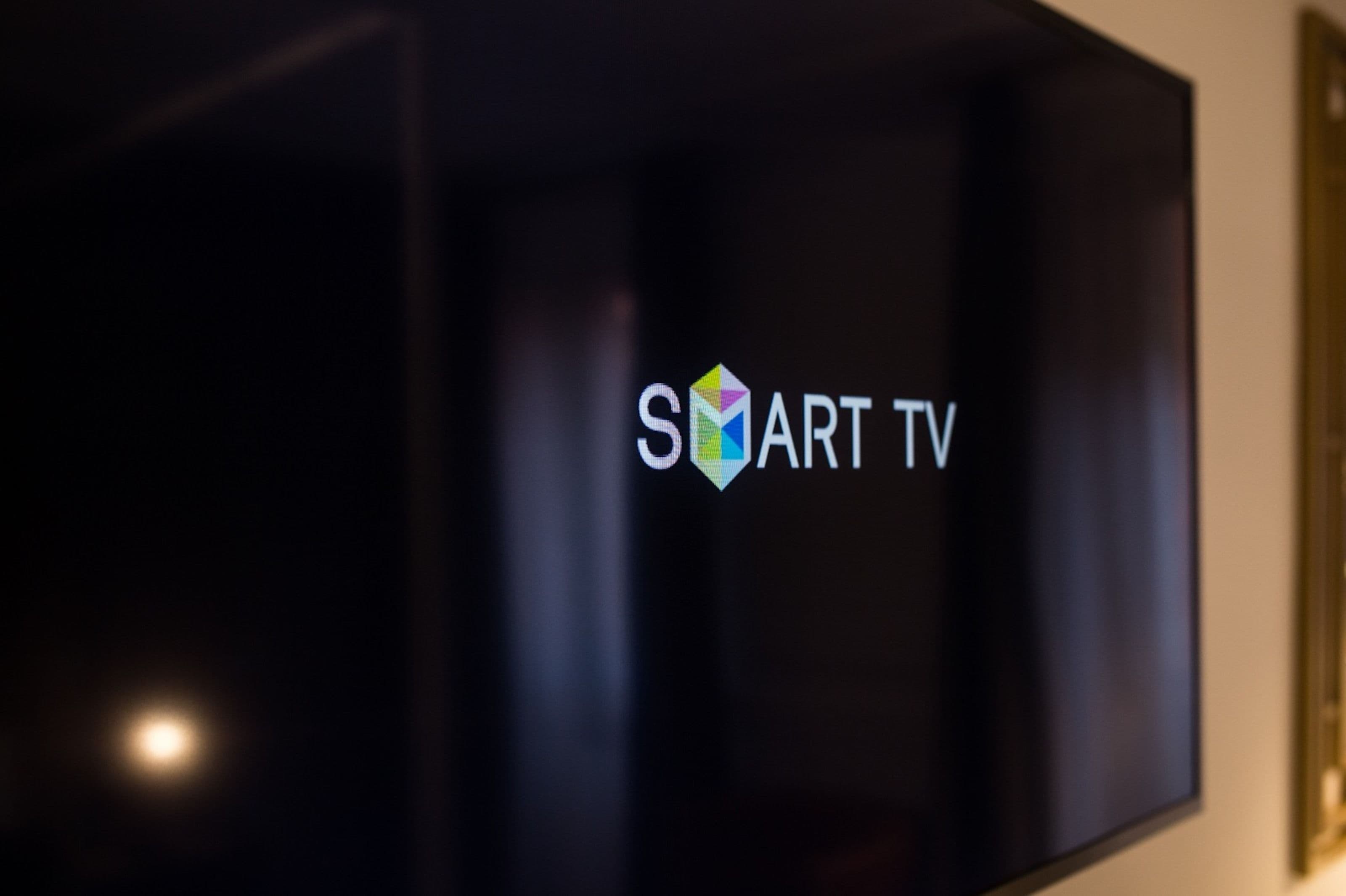 A flat-screen TV with the logo "SMART TV" on a wall.