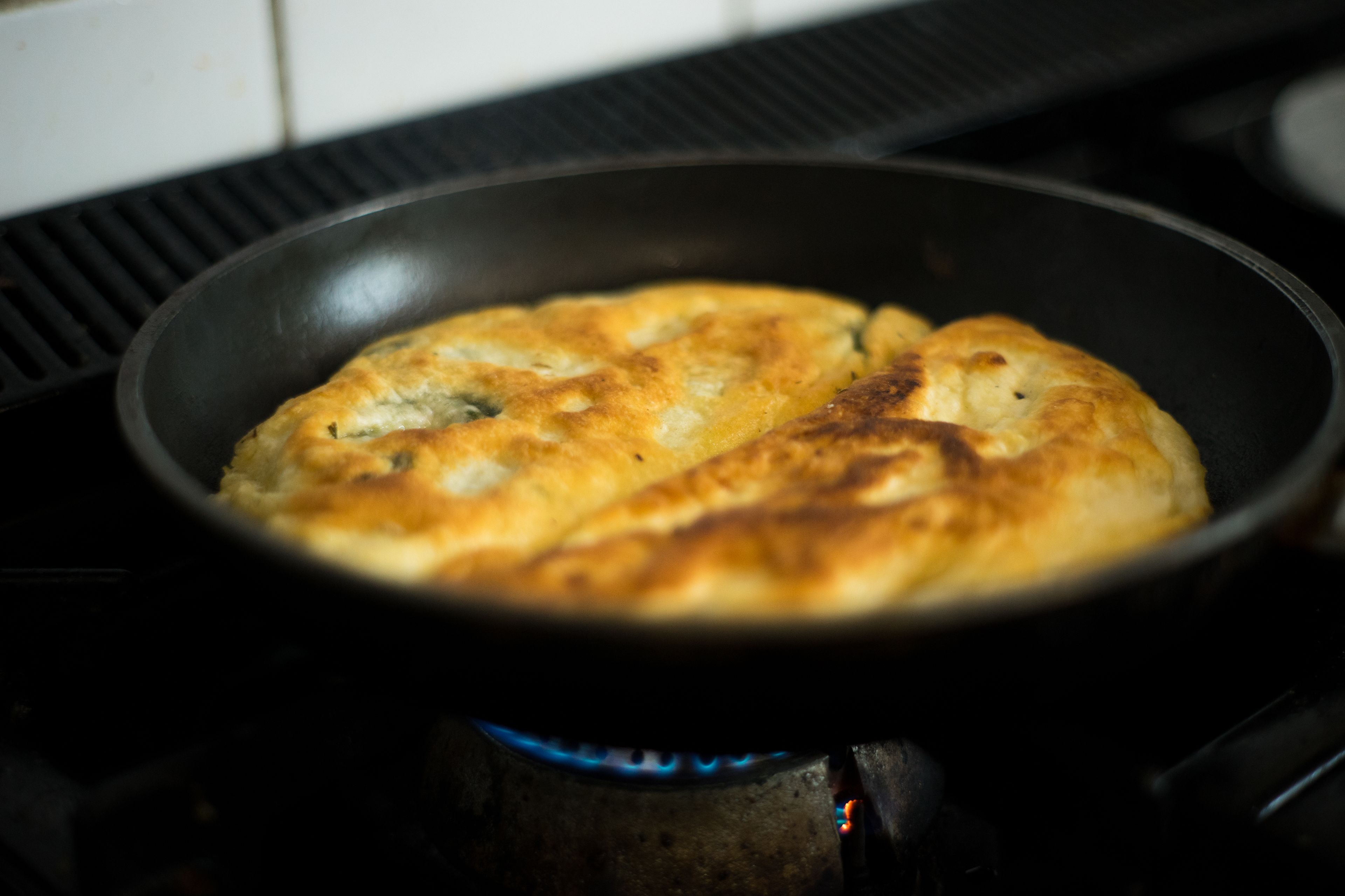 A pan on a stove with a baked item.