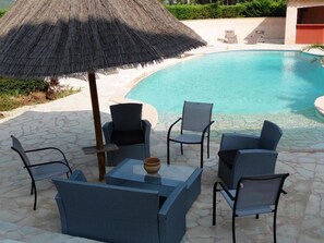 Seasonal outdoor pool, open 9:00 AM to 9:00 PM, pool umbrellas
