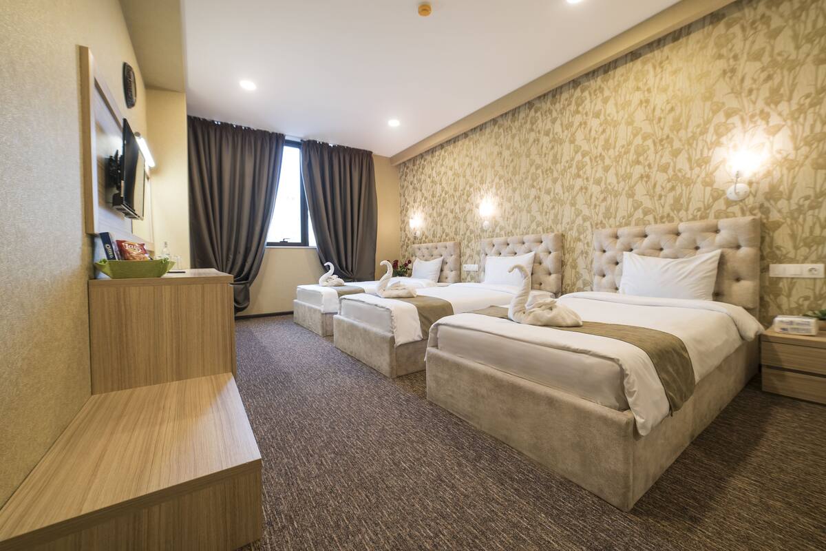 Standard Triple Room | Minibar, in-room safe, desk, iron/ironing board