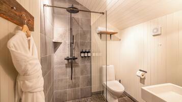 Un baño con ducha, inodoro y lavamanos.