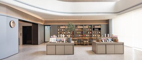 A modern interior with a central seating area, a bookshelf, and a sign reading '2040 BOOKSTORE'.