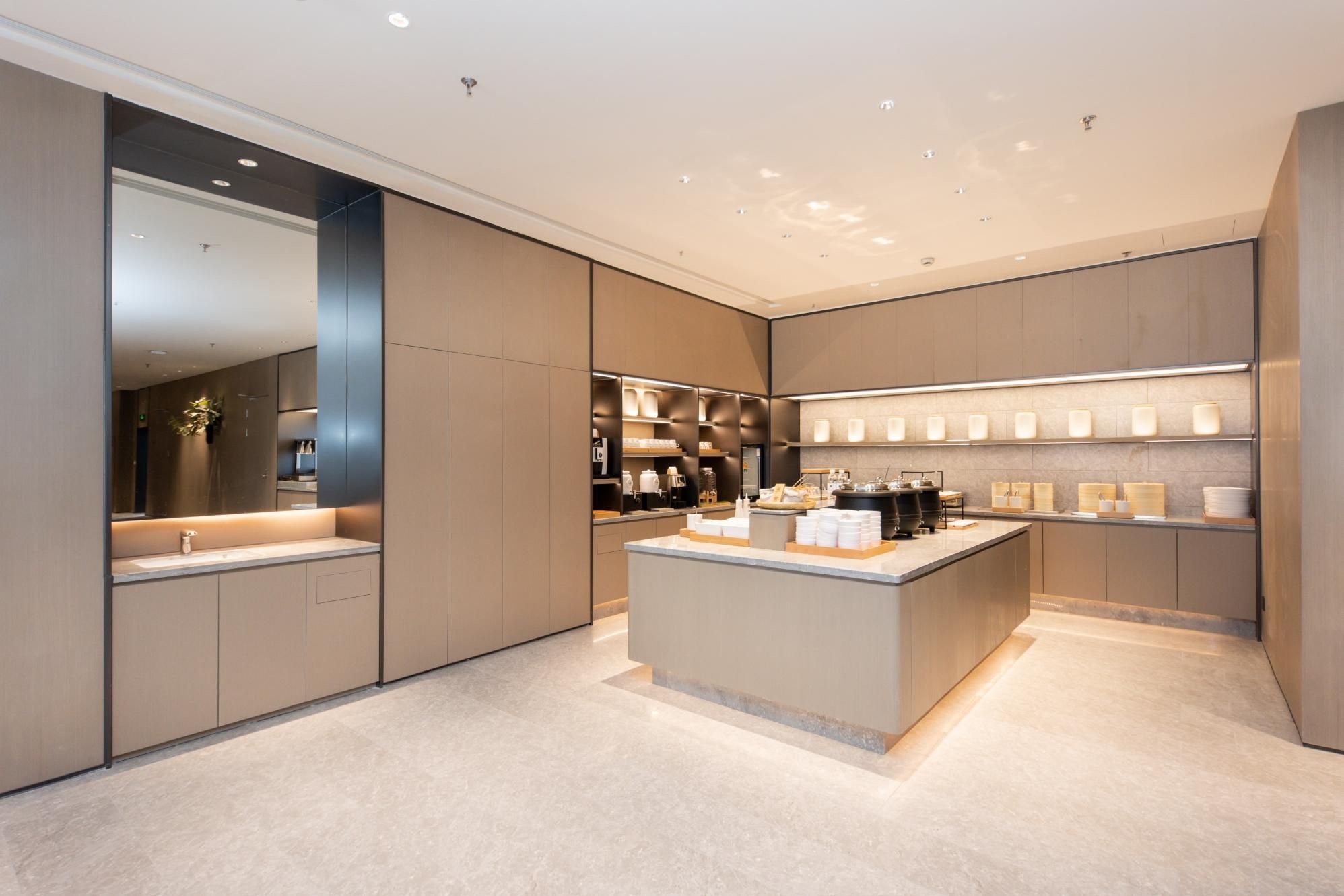 A modern kitchen with a central island, built-in appliances, and a sleek design.