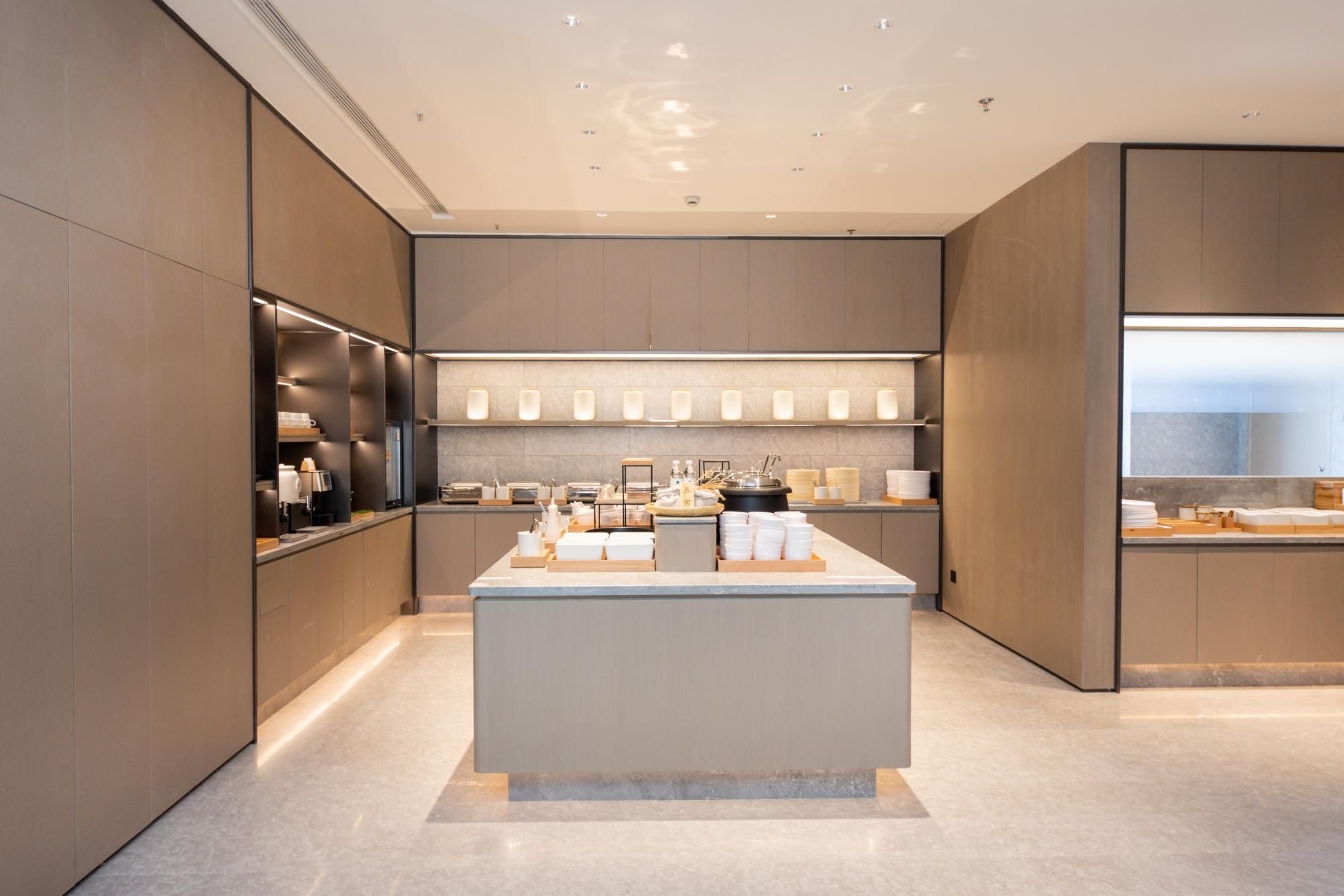 A modern kitchen with a central island, built-in appliances, and a sleek design.