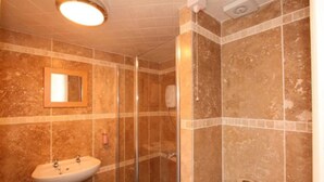 A bathroom with a sink, mirror, shower, and toilet. - Central Studios Gloucester Road by Rooms Booked - Free Parking (Cheltenham)