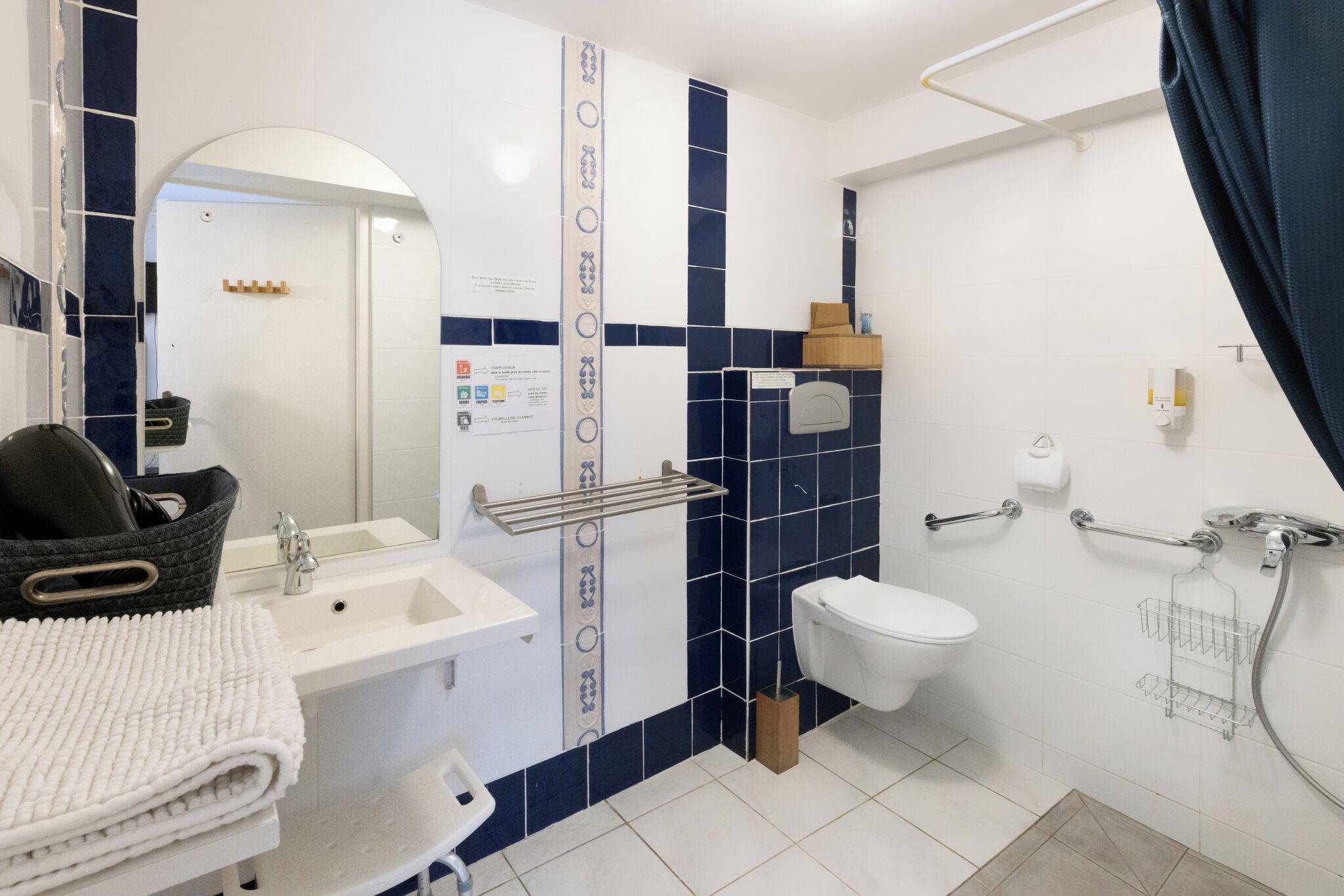 A bathroom with a sink, toilet, and shower area.