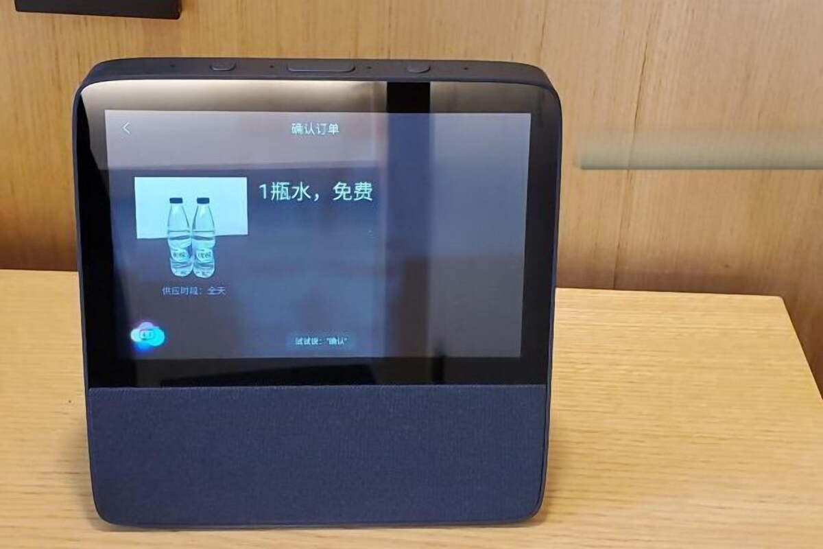A tablet with a dark case on a wooden surface.