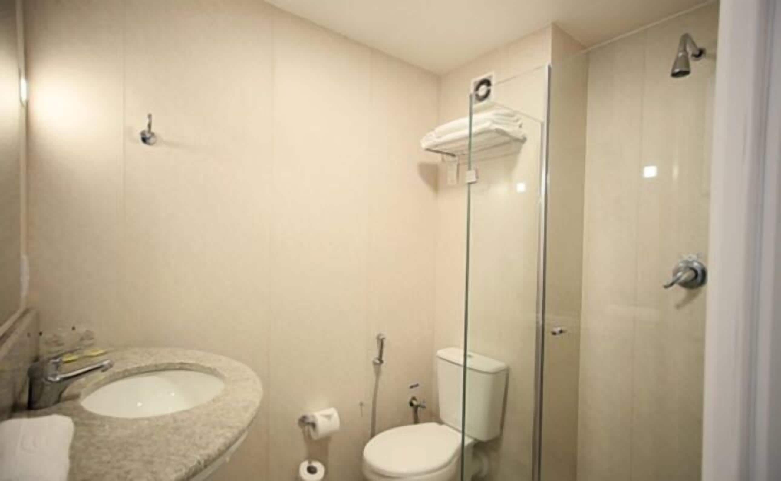 A bathroom with a sink, toilet, and shower.