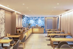 A modern dining area with a counter and seating.