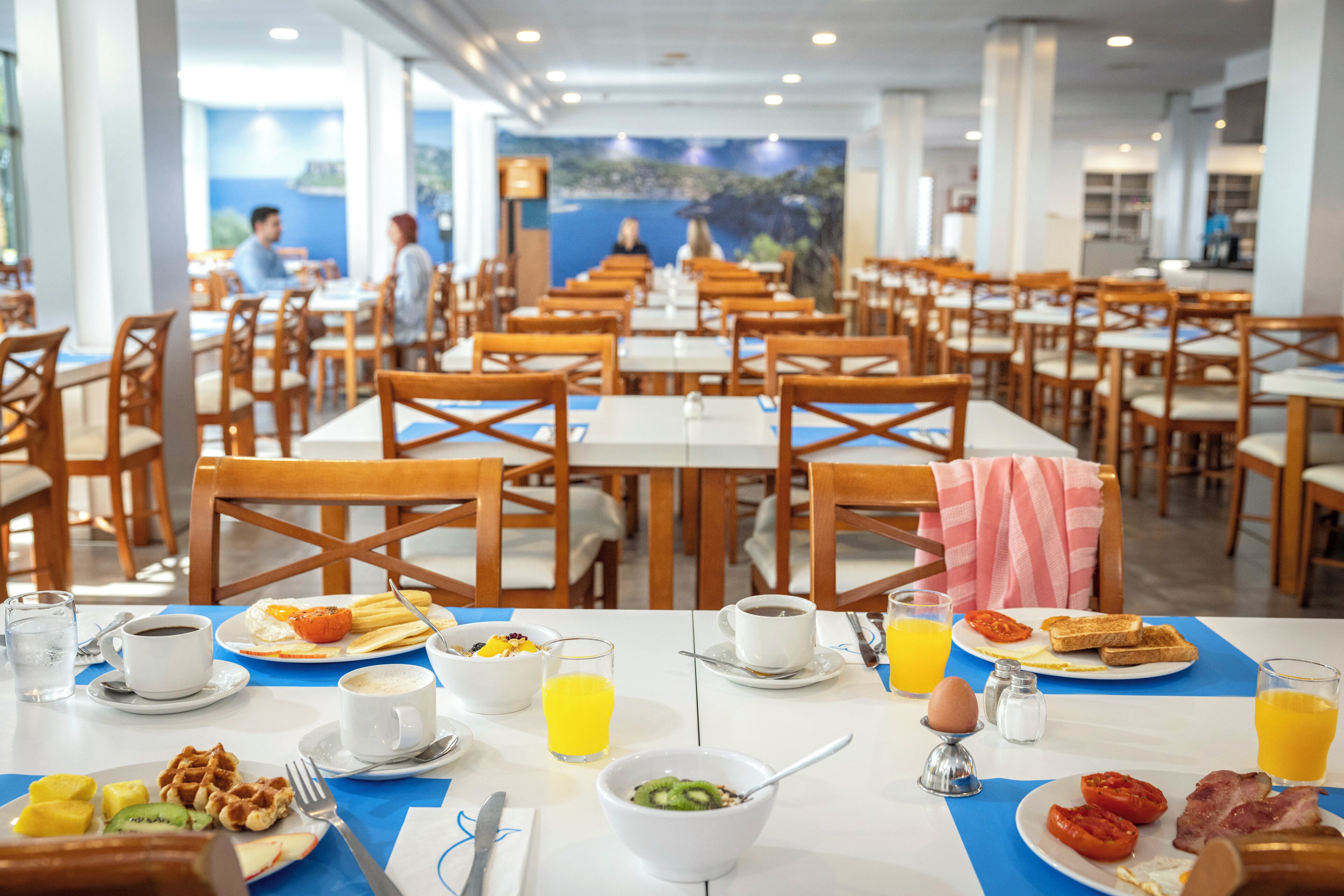 A breakfast buffet with various food items and beverages.