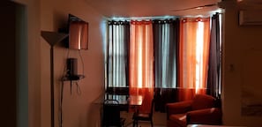 Enjoy a compact living space with a dining area, television, and table for two.