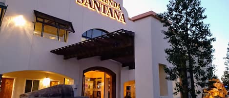 A hotel entrance with a sign reading "Hacienda Santana."
