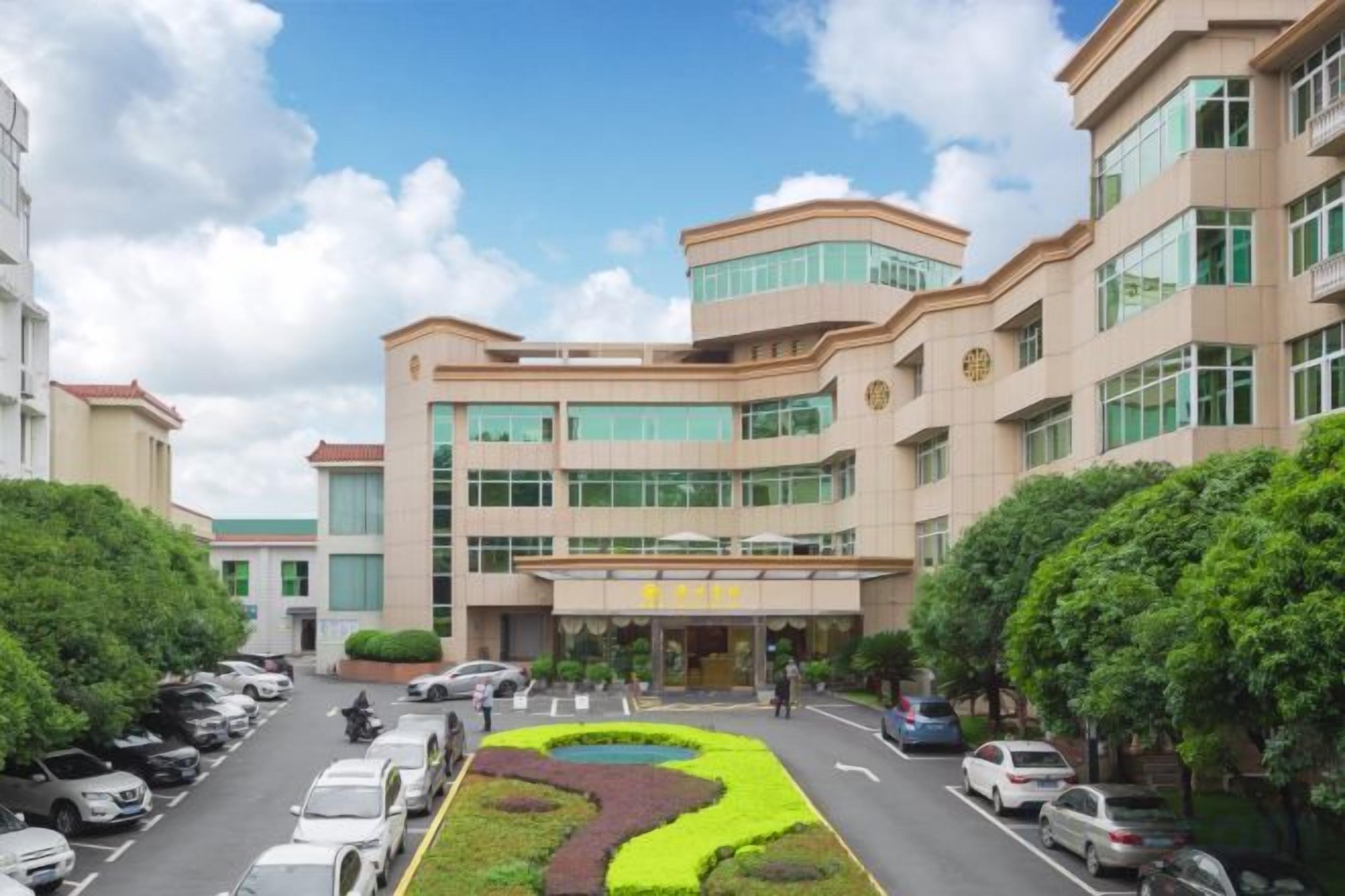 A multi-story building with a parking lot and landscaped area in front.