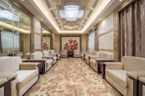 A hotel conference room with a marble floor, multiple seating arrangements, and a chandelier. - Ganzhou Hotel (Ganzhou)