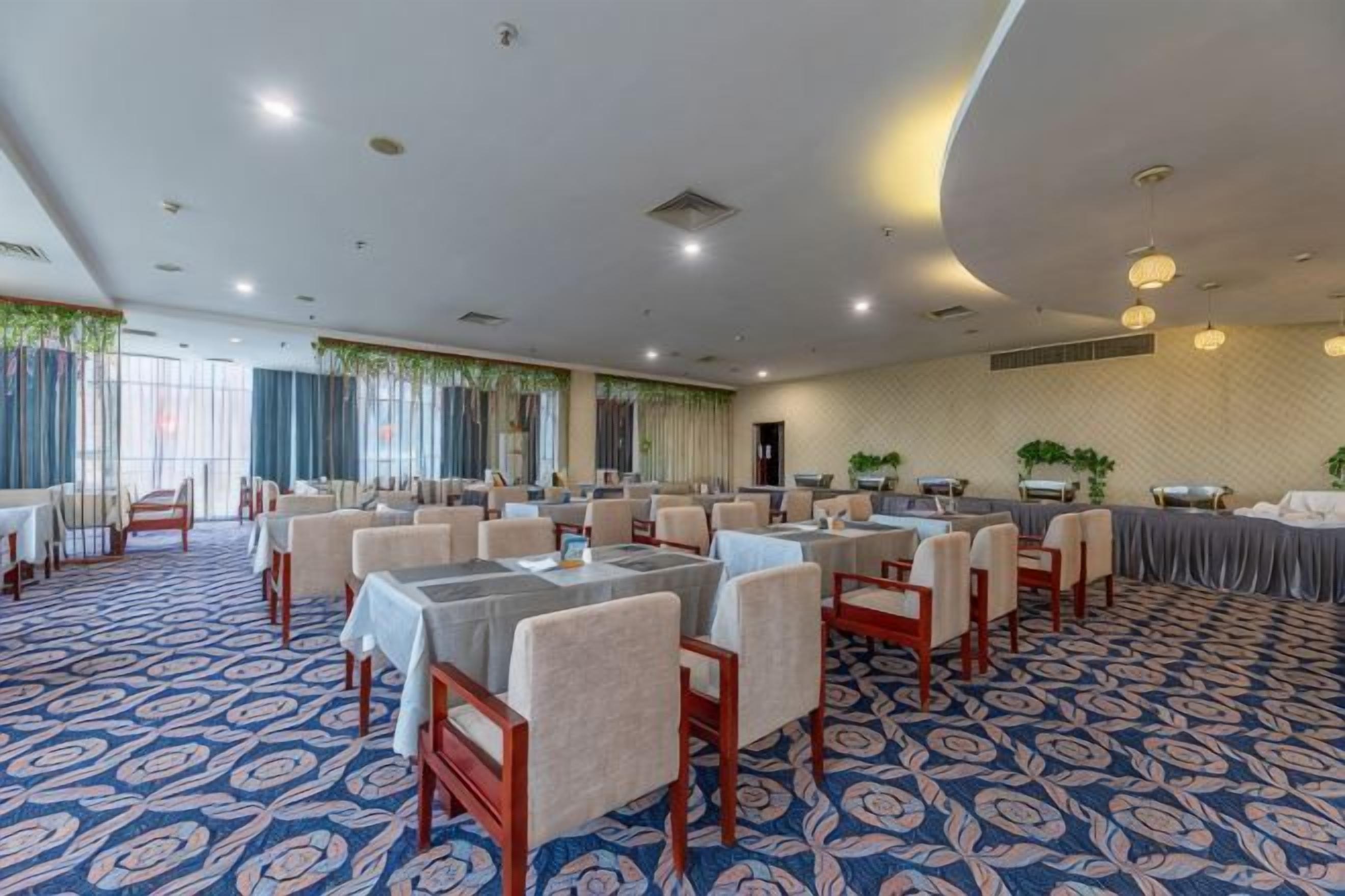A conference room with tables and chairs arranged for a meeting.