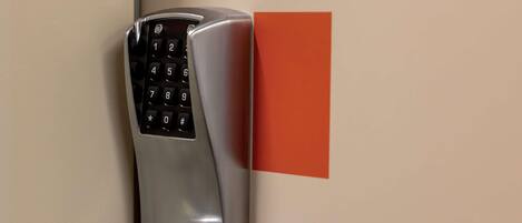 A modern door lock with a numeric keypad and a keyhole.