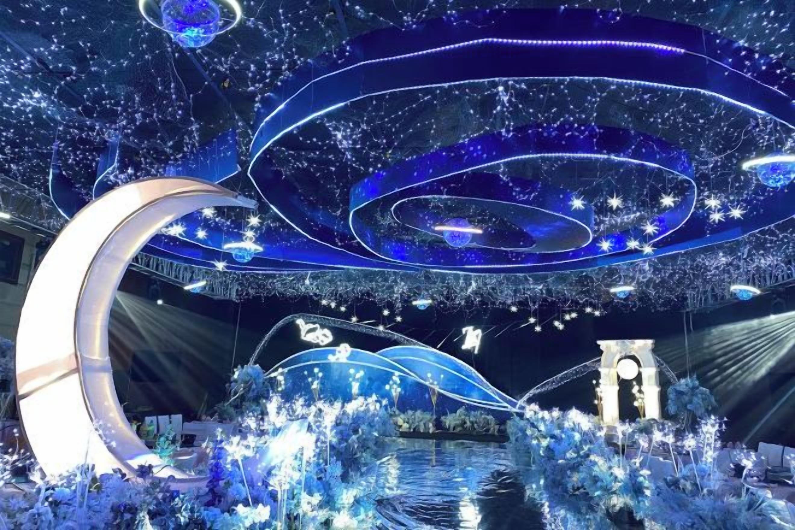 A modern interior with a circular architectural feature, a water body, and decorative lighting.