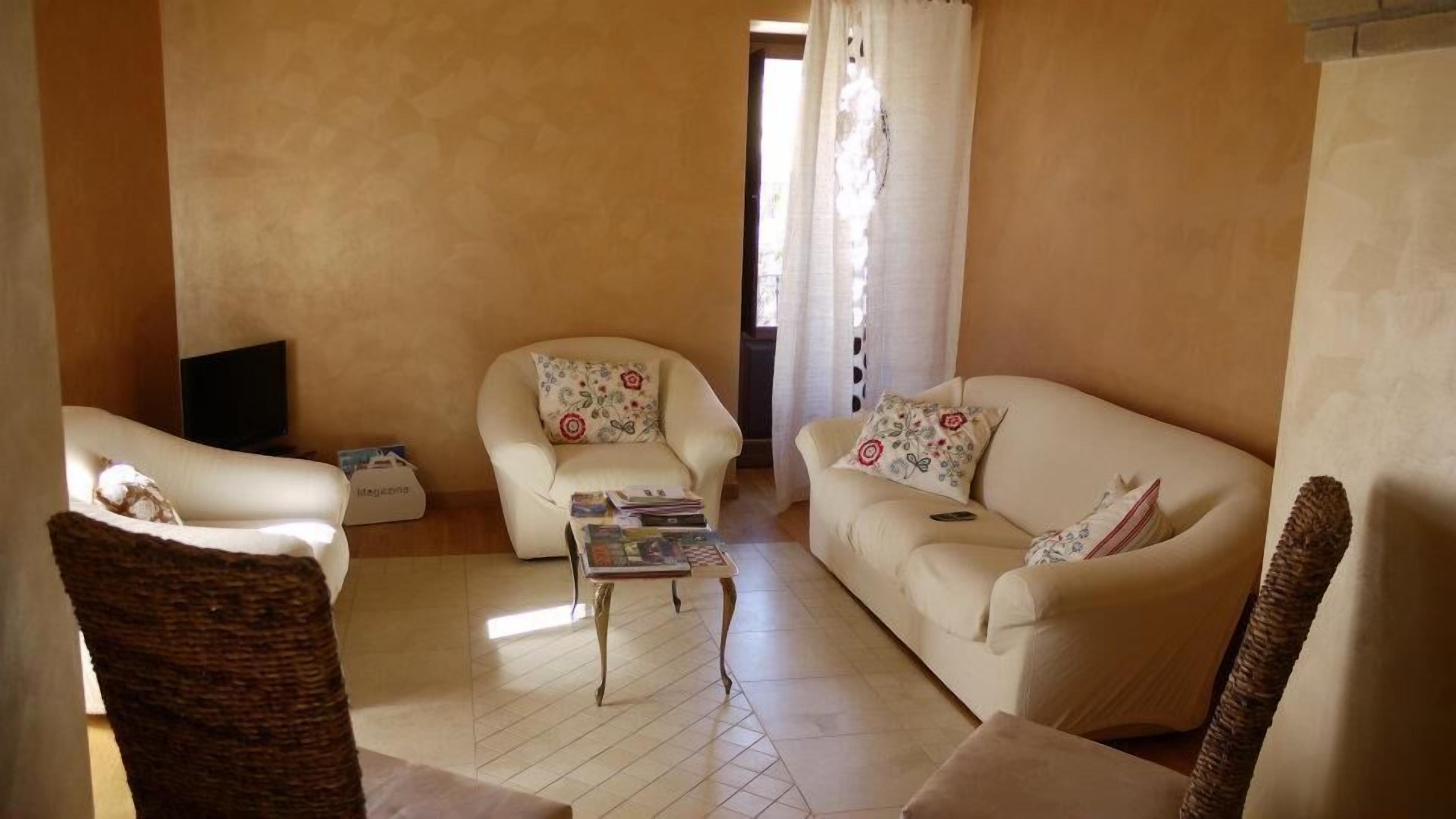 A living room with two sofas, a coffee table, and a television.