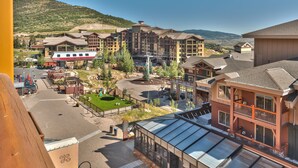 A resort with multiple buildings, a parking area, and a mountain backdrop. - Sundial Lodge (Park City)