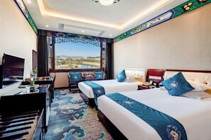 A hotel room with two beds, a desk with a TV, and a view of a cityscape. - Chabofu Charenju Hotel (Wuyuan)