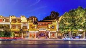 A traditional building with multiple levels and ornate architectural details, likely a hotel or cultural site. - Chabofu Charenju Hotel (Wuyuan)