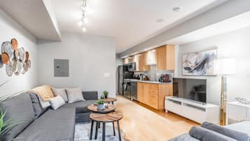 Deluxe Condo, Multiple Beds, Non Smoking | Living room | 43-inch LED TV with cable channels, TV, Netflix