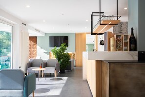 A modern interior with a bar area, seating, and a large window.