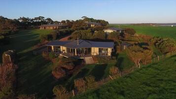 Relax in a serene setting surrounded by lush greenery and expansive fields.