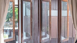 A window with four panes, each with a wooden frame and a glass surface. - The Mellow Pillow at Chiang Mai Gate (Chiang Mai)