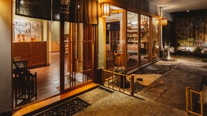 A traditional Japanese-style restaurant with wooden interiors and a stone pathway leading to the entrance. - MAYU Bangkok Japanese Style Hotel (Bangkok)