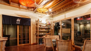 A traditional Japanese-style interior with wooden floors, tatami mats, and a tea house. - MAYU Bangkok Japanese Style Hotel (Bangkok)