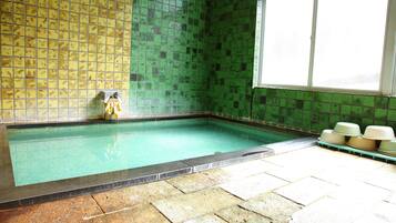 Relax by the pool, surrounded by vibrant tiles and natural light.