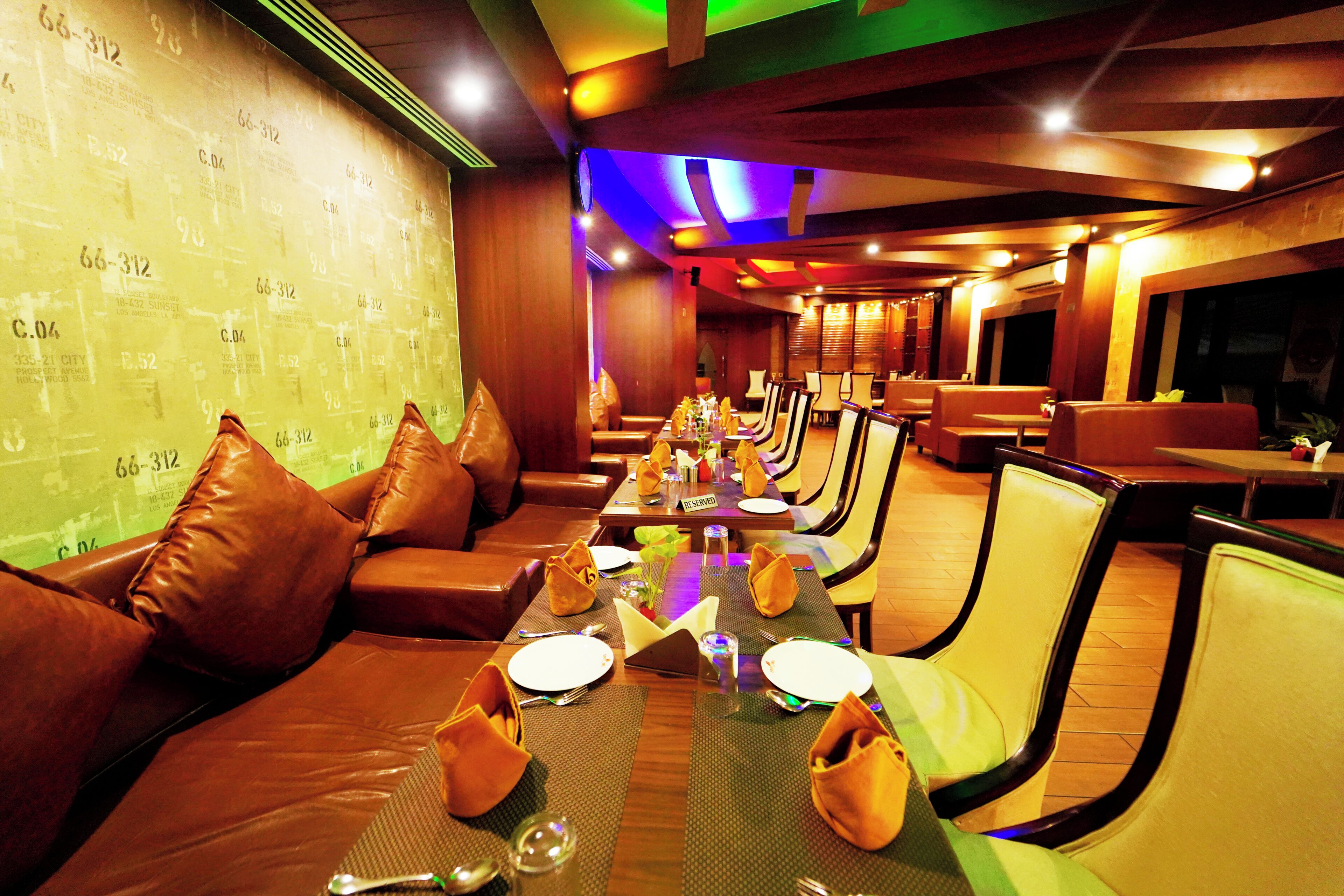 A restaurant with multiple dining tables, chairs, and booths.