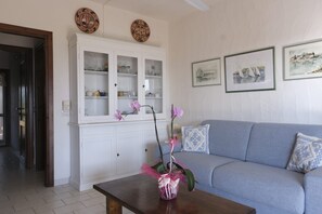 Apartment, 1 Bedroom | Living area | 32-inch TV with digital channels