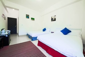 A hotel room with two beds, a desk with a chair, and a door. - Dong Pan B&B (Shoufeng)