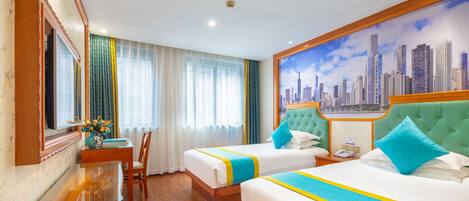 A hotel room with two beds, a cityscape mural, a wooden desk, and a chair.