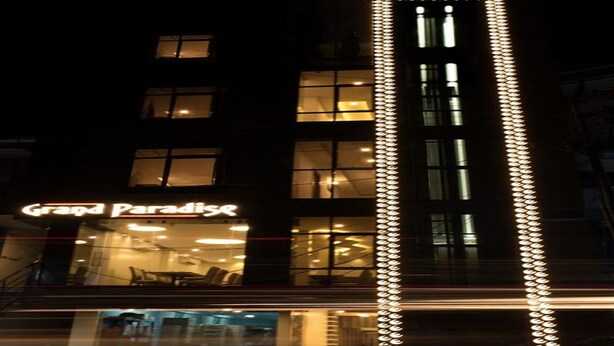 A building with a sign reading "Grand Paradise" and a vertical light strip on the facade. - Grand Paradise (Port Blair)