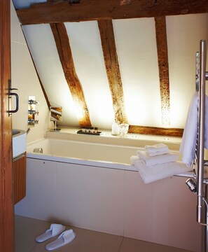 Deep-soaking bathtub, rainfall showerhead, free toiletries, hair dryer